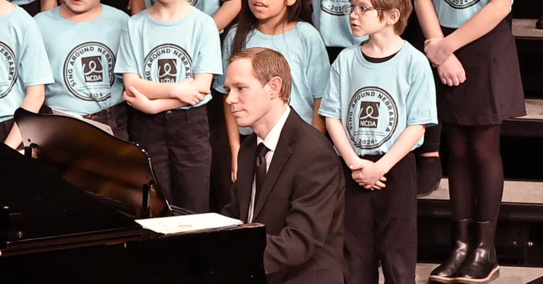 Why We Sing Saturday was a busy day for many local students who were able to take part in the Sing Around Nebraska clinic and performance. The day was complete with many local faces taking to the Performing Arts Center stage including elementary music director Micah Hesterman who played the piano.