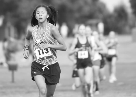 GRACE NOKELBY leads a pack of runners at the Roger Nielsen Invitational at the Valley View Country Club. Nokelby led Nebraska Christian with a third place finish. Photos by Jordan Coslor