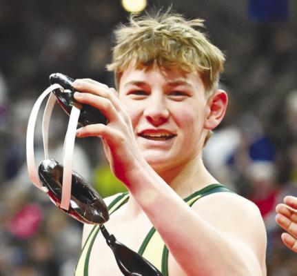 QUINN JENSEN was all smiles after a win during last week’s NSAA Class C State Wrestling Championships in Omaha. Jensen won three matches at the tournament and finished with a record of 51-6.
