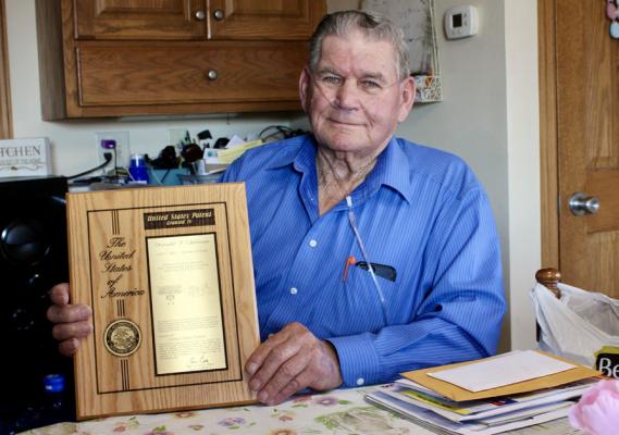 Don holding the United States Patent granted to him in June of 2003 for the piece of machinery he named Row Wrangler.