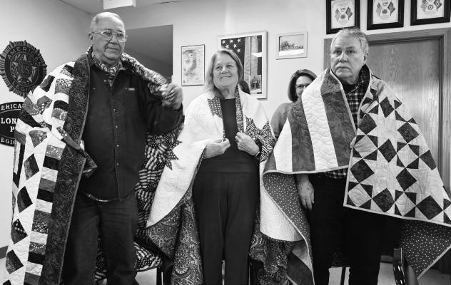 THE LONE TREE QUILTERS awarded three Quilts of Valor during Veterans Day observances in Central City on November 11th. Pictured with their individual quilts are Richard Ogden, Jean Polzkill, and Curt Hueftle. The program was made possible thanks to the financial assistance of the Merrick Foundation. Courtesy Photo