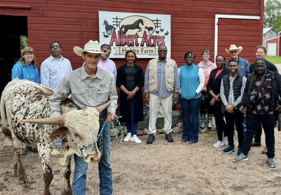Special Guests Keir Albert (pictured with longhorn) has found success with his businesses and he recently was able to show off that success to a group from Kenya