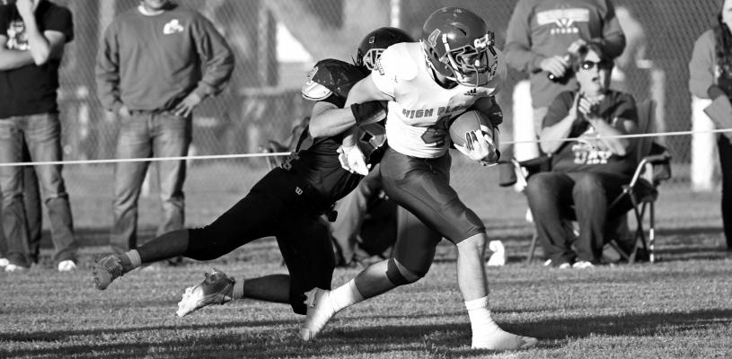 AARON BROWN drags a Palmer defender down field in last Friday’s game between High Plains and Palmer. Brown finished the game with seventeen rushing yards. Photos by Michael Happ