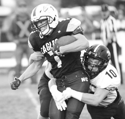 TITUS BIRNIE drags a Howells-Dodge defender for a big gain in the first quarter of Nebraska Christian’s game with the Jaguars.