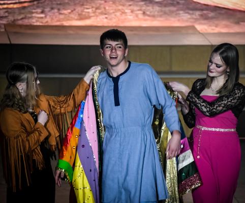 Narrator Adeline Davenport (left) helps place Joseph’s Technicolor dreamcoat on Brock Olivo (center) with the help of Katelynn Blomstedt (right). (R-N Photos and Story by Ryan Dettman)