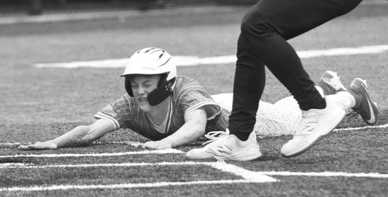 QUENTIN HERMAN slides safely across home plate following a passed ball in the third inning of Central City’s game with Grand Island Pro Team Design last Thursday at Ryder Park. Photos by Jordan Coslor