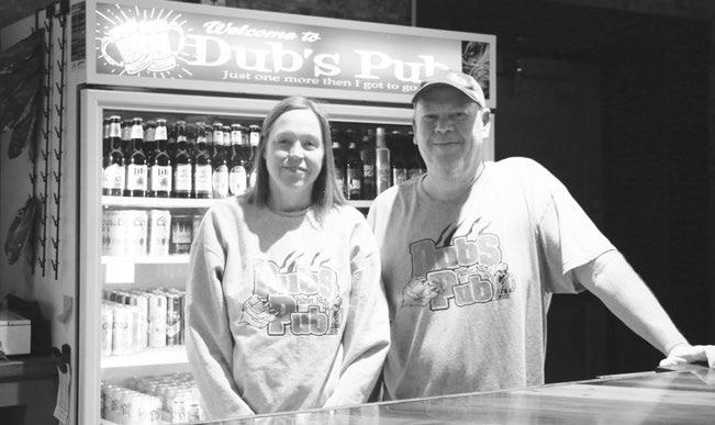 DUBS PUB owners Kristi and Jamie Weller pose for a photo in their expanded bar and eatery in downtown Palmer. The Wellers held a grand opening bash for their establishment on Saturday. Photo by Michael Rother