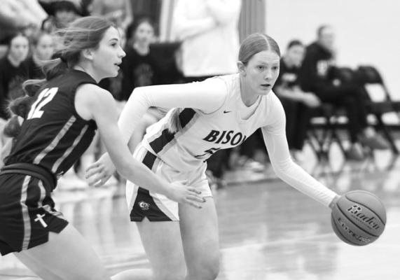 CENTRAL CITY’S JOURNI SCHINDLER dribbles through some tight defense from Nebraska Christian’s Emma Rathjen. Schindler finished with ten points, six assists, and six steals in the Bison’s 63-25 win. Photos by Jordan Coslor