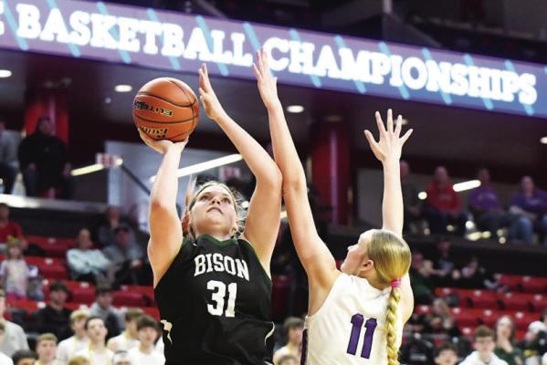 HOPE PAUP scores in the paint through contact from Milford’s Shayla Rautenburg. Paup led Central City with eleven points in their state tournament game with the Eagles. Photos by Jordan Coslor