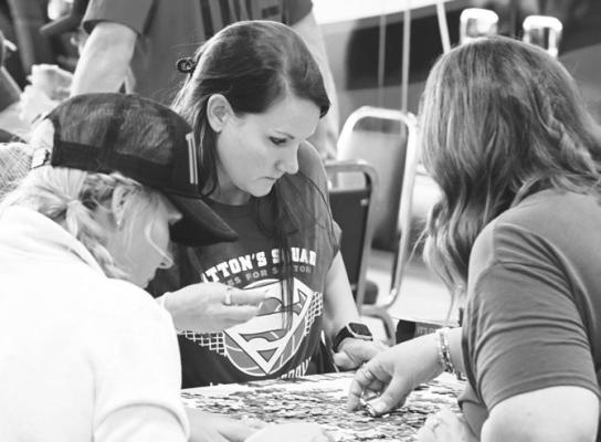 KRISTIN TRENHAILE works to put together a puzzle during Saturday’s Pizza, Puzzles, and Pub event in Palmer. Photo by Michael Happ