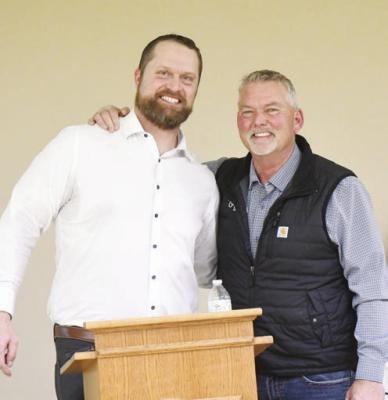 FORMER NEBRASKA CORNHUSKER ADAM CARRIKER poses for a photo with Nebraska Corn Growers President Brian Brown last week. Photo by Jordan Coslor