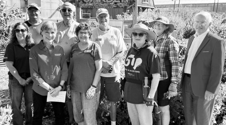 TERRI JAMES (left), program coordinator, and a team of Master Gardener Volunteers pause for a photo in the Backyard Farmer Garden. Dr. Jeffrey P. Gold (right), president of the University of Nebraska system, and Kim Todd (front row, second from left), “Backyard Farmer” host, joined them while filming a video segment for the show. Effie Athanassopoulos and Gwendŵr Meredith