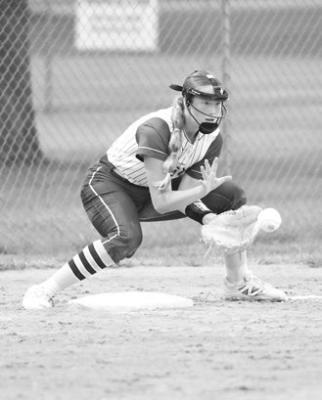 BROOKLYNN STEINKE reels in a throw at third base for an out.