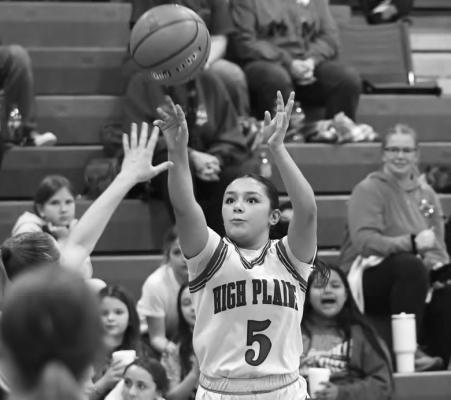 GAHVI LESIAK shoots and scores on a contested three-pointer in the third quarter of High Plains’ win over Grand Island Lutheran. Photo by Jordan Coslor