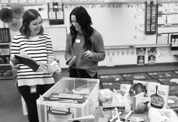 EXTENSION EDUCATOR ALYSSA HAVLOVIC (right) works with a teacher and goes through a kindergarten kit. Each classroom kit includes a lesson book and materials for hands-on learning, such as science experiments, interactive games, books and more.