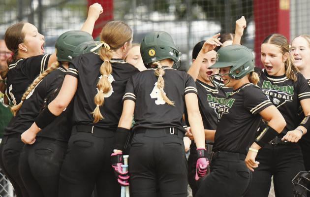 JUNO RYAN is greeted at home plate after hitting Central City’s first home run of the season during the second inning of the Bison’s 11-1 victory over Boone Central. Photos by Jordan Coslor