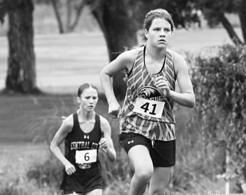 NEBRASKA CHRISTIAN’S MCKINLEY MANKIN makes her way up the final hill at the St. Paul Country Club last week, with Central City’s Amelia Buhlke right behind her. Mankin won the individual title at the St. Paul Invitational with a time of 20:43. Photos by Michael Happ