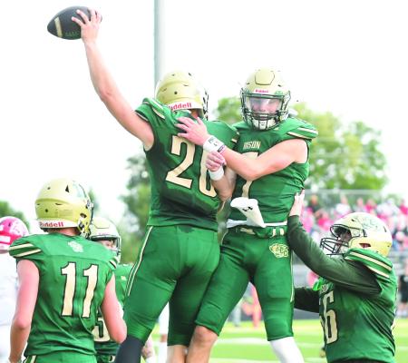 CENTRAL CITY tight end Turner Hanke and quarterback Parker Zikmund celebrate after Hanke reeled in a touchdown pass for the Bison’s first score of the season. Photos by Jordan Coslor