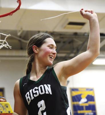 PAYTON BURBACH celebrates after cutting down the net at Raymond Central High School on Friday evening. Photos by Jordan Coslor