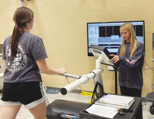 GABBY AND SOPHIE MOSER, sisters from Central City, are working together on a research project benefiting Gabby’s work at the University of Nebraska at Omaha and Sophie’s work as part of Central City High School’s Advanced Biology Science Research Project. Pictured, Sophie, right, helps gather gait data. Courtesy Photo