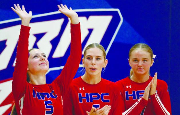 BROOKLYN WELCH blows kisses to the heavens on Thursday night during starting lineups of the Storm’s volleyball match against Nebraska Christian. Joining Welch in the lineup are Bailey Gress and Taya Hans. Photos by Michael Happ