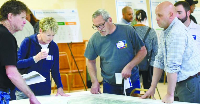 AREA RESIDENTS, community stakeholders, and representatives from the Nebraska Public Power District look over plans for a proposed transmission line project. Photo by Jordan Coslor