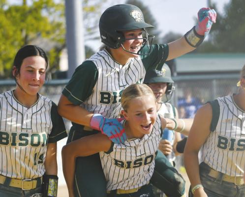 ADDIE BURBACH AND SOPHIE MOSER celebrate after Burbach’s home run in the second District Final game.