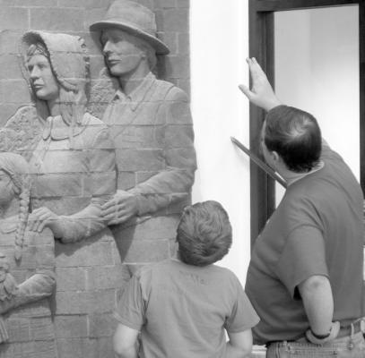 Those who turned out for the Go Big GIVE celebration at the new Merrick County Historical Museum were treated to a first-hand look at the facility. That included Lucas and Scott Musil who admired the craftsmanship of the buildings center piece. (R-N Photo by Grant)