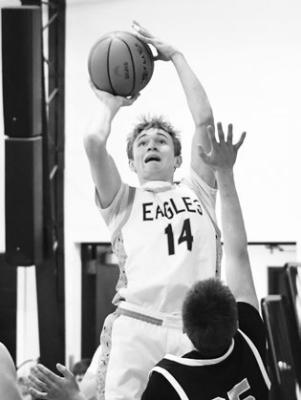 BARON FALK scores two points on a jump shot in Nebraska Christian’s game with H&amp;H. Photo by Jordan Coslor