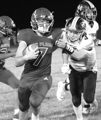 KYLER HANS (left) drags a Giltner defender for a big run in last Friday’s 80-34 win.