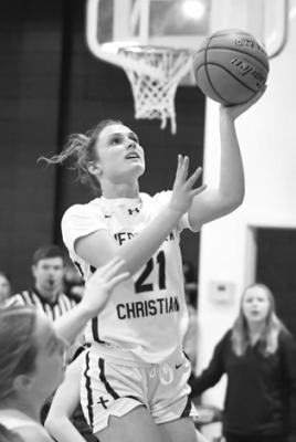 SHERIDAN FALK caps off a fast break with a layup in Nebraska Christian’s win over H&amp;H. Photo by Jordan Coslor