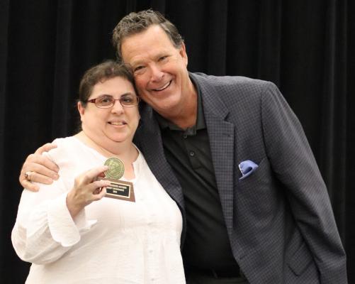 Sandy holds one of her awards proving hard work does pays off.