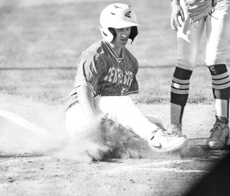 ERIK BLOMSTEDT slides safely across home plate in the fifth inning of Central City’s game with Centura last Thursday at Kernel Field.