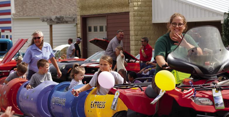 All Aboard This past Saturday brought with it plenty of fun for the residents and visitors to Chapman as they hosted their annual Fall Festival. The day featured plenty of exciting family entertainment options, shopping and even a parade through town. Hannah Clark, Executive Director of the Platte Peer Group who oversees Bader Park, smiles and waves as she drives the Park’s Outdoor Express. (RN Photo by Jacob Kennedy)