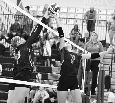 SYDNI HOMOLKA battles at the net for the ball in Central City’s 3-2 loss to Aurora. Homolka led the Bison with twenty-seven kills in the match. Photos by Michael Happ
