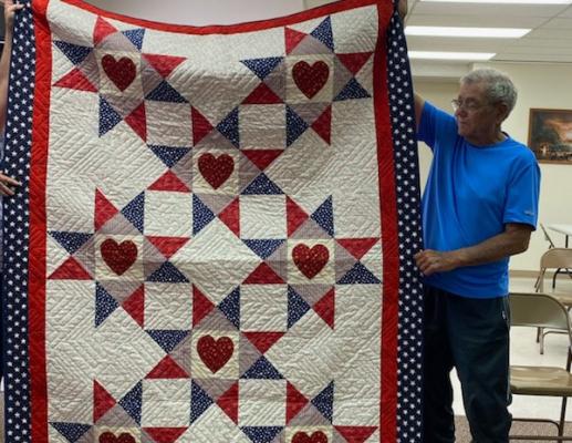 Richard Owens receives a Quilt of Valor during a ceremony at the Polk Senior Center.