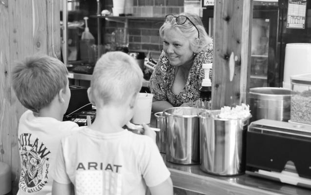 TWO YOUNG BOYS buy ice cream from the owner of Sandhills Ice Cream and Treats in Valentine, in May 2023. Russell Shaffer | Rural Prosperity Nebraska