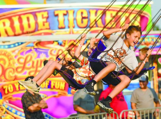 THE D.C. LYNCH SHOWS carnival was a big draw on the midway on Monday night during the Merrick County Fair. Above, Drew Friedrichsen was one of the many kids that enjoyed the rides at the fair. Photo by Jordan Coslor