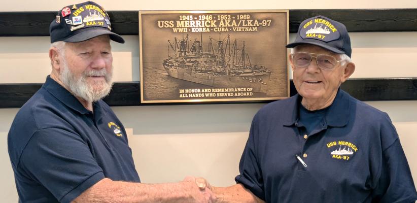 Merrick Memorial Ferrell Morrow shakes hands with Bill Bolte as the USS Merrick was honored with a new plaque inside the Merrick County Historical Museum.