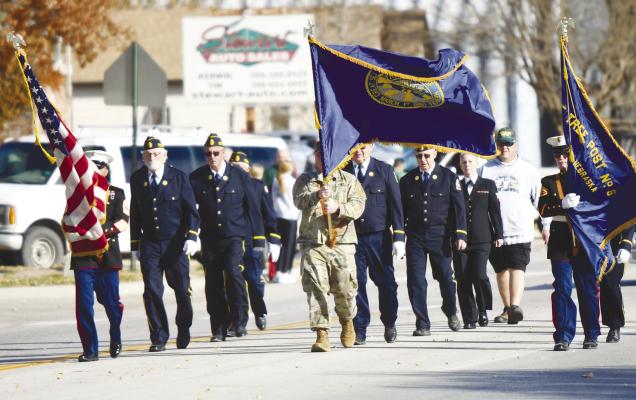 CENTRAL CITY observed Veterans Day with myriad activities on Tuesday, November 11th, including the community’s annual Veterans Day Parade. This year’s event was graced by beautiful weather and was well attended. Above, members of the Central City American Legion Post 6 escort the colors along the parade route. Below left, candy flew through the air from a variety of floats. Below right, the American flag was on full display last Tuesday afternoon. Photos by Jordan Coslor