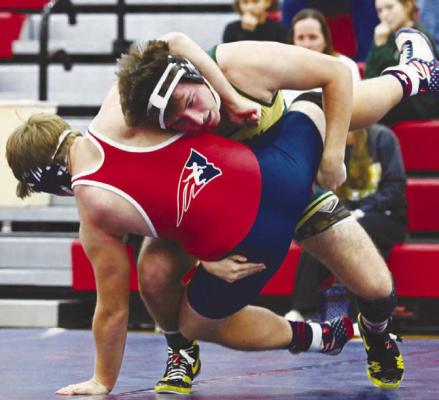 NATHANIEL LUEBBE works to pin Adams Central’s Jaxon Perkins in fifty-five seconds on Thursday during the Bison’s dual with the Patriots. Photos by Michael Happ