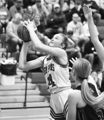 TAYA HANS slips past the Riverside defense and lays it in for two of her fourteen points. Alongside her scoring effort, Hans grabbed ten rebounds to help the Storm to their 49-37 win. Photos by Jordan Coslor