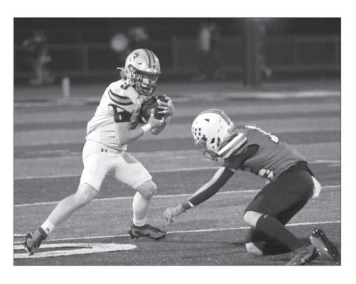 JACOB BRAZEE skirts around an Aurora defender after making an interception in the second quarter of Central City’s 27-12 loss to the Huskies last Friday.