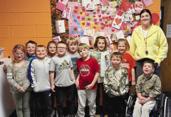 PALMER ELEMENTARY SCHOOL’S first grade class is pictured next to a portion of their collection of Valentines from all fifty states in America. Courtesy Photo