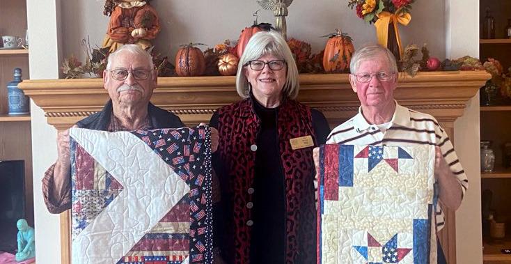 On October 29, Pat Becker, a member of the Quilt of Valor Foundation, presented quilts to Ron Schafer (right) and Robert Fuelberth (left) at the Schafer home. The Quilt of Valor mission is to cover service members and Veterans touched by war in comforting and healing Quilts of Valor as a way to say “thank you for your service and sacrifice.” (Courtesy Photo)