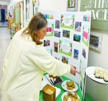 MERRICK COUNTY CHILD DEVELOPMENT CENTER Director Amy Kucera shows off some of the items highlighted during the center’s open house. Photo by Michael Happ