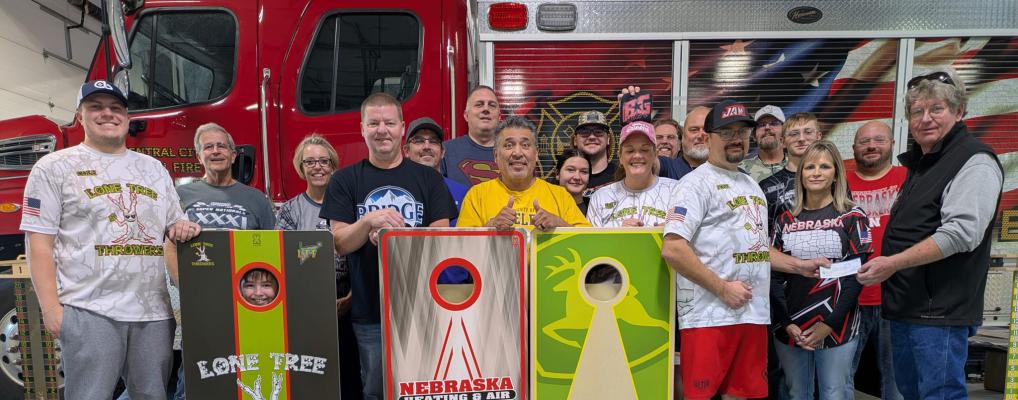 The Lone Tree Throwers utilized the Central City Fire Department for their league and in turn were able to donate money back to the department. To the right Josh Fousek hands Fire Chief Brad Wells a check to thank the department for letting them use the space during the season.