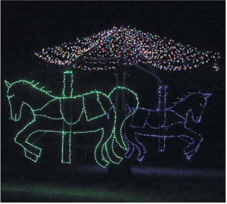 VISITORS TO THE WORMS CHRISTMAS LIGHT SHOW in rural Merrick County have the opportunity to catch a glimpse of multiple displays, including its iconic rotating carousel. Photo by Michael Happ