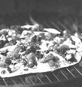 Turn a backyard (or indoor) grill into a pizza oven