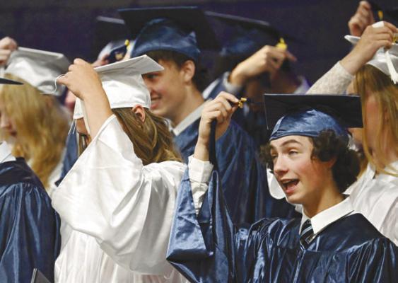 MEMBERS of the Nebraska Christian Class of 2026, including Sheridan Falk and David Carlson, turn their tassels during last week’s graduation ceremony. Twenty-six students received diplomas last Saturday. Photo by Michael Happ